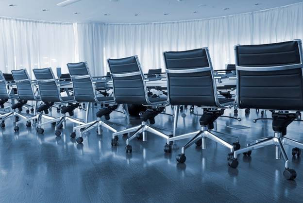 Conference room with a row of modern, empty office chairs.